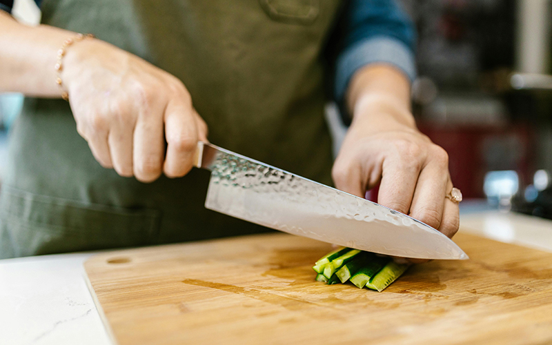 Mann schneidet Gemüse